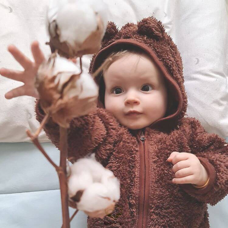 Best nursery colors: baby in a setting with a beige aesthetic Best nursery colors: baby in a setting with a beige aesthetic