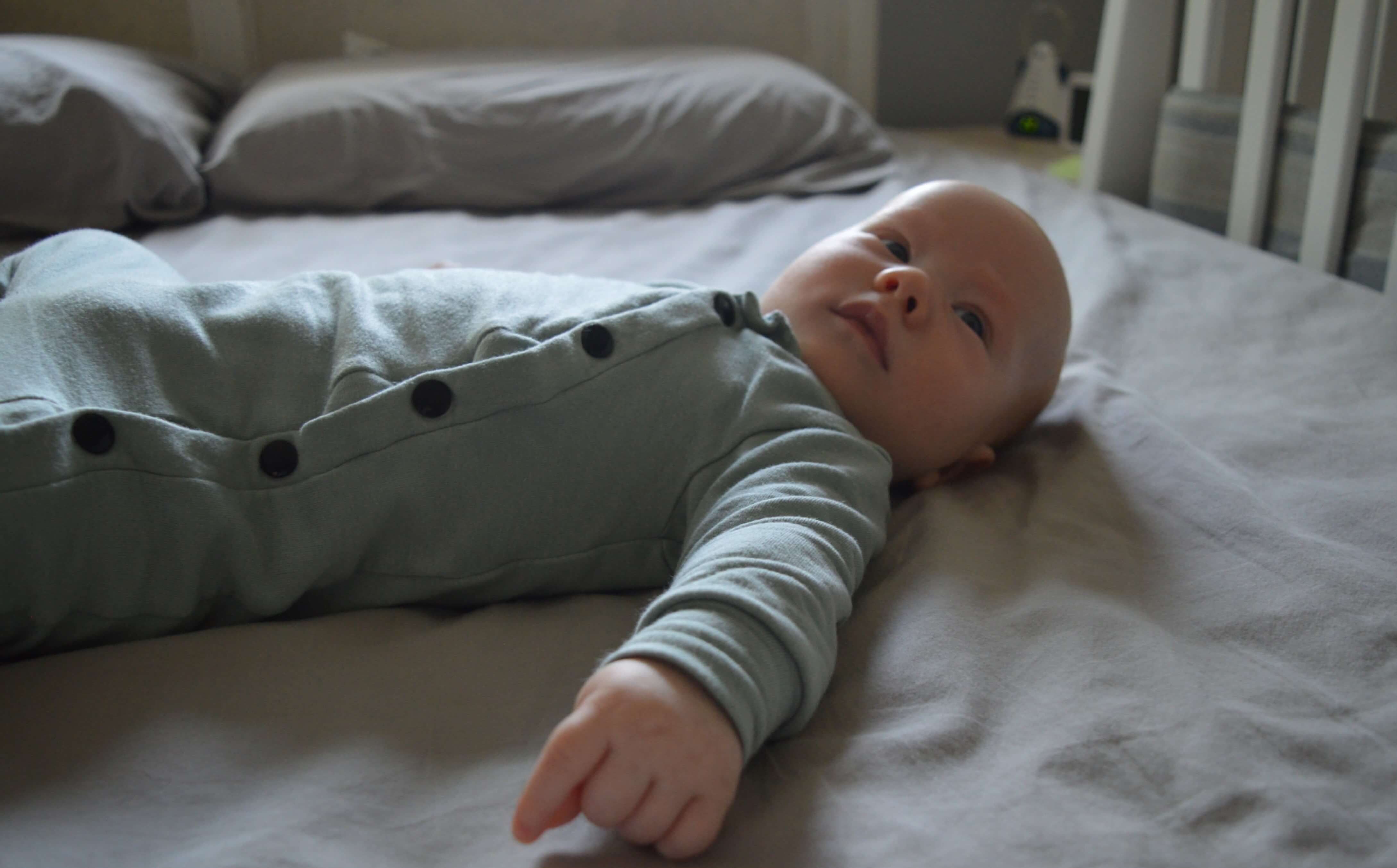 Calm baby lying on bed Calm baby lying on bed