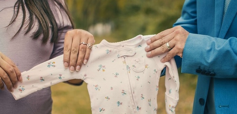 Parents holding baby sleeper Parents holding baby sleeper