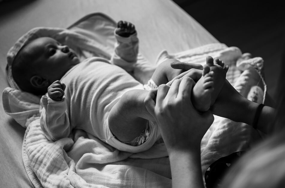 Newborn receiving foot massage Newborn receiving foot massage