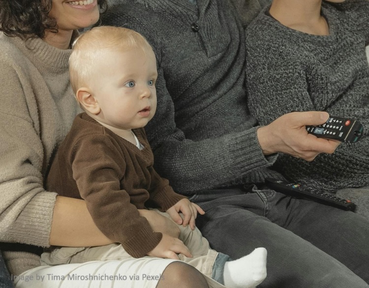 baby on lap watching tv