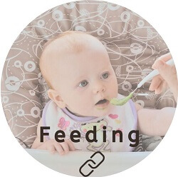 Baby being fed avocado by spoon