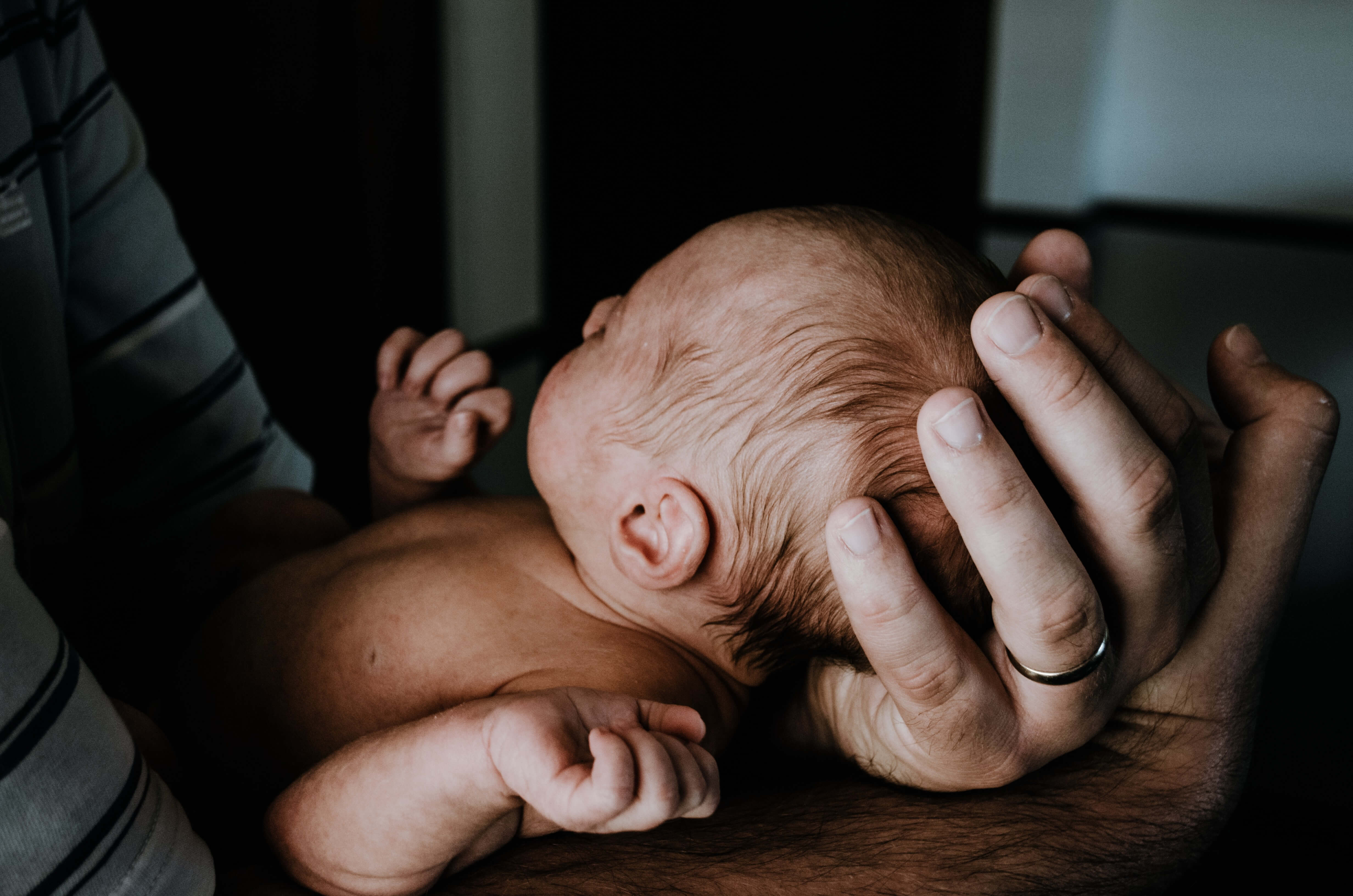 Parent holding baby gently and mindfully showing one of the ways how to build attachment